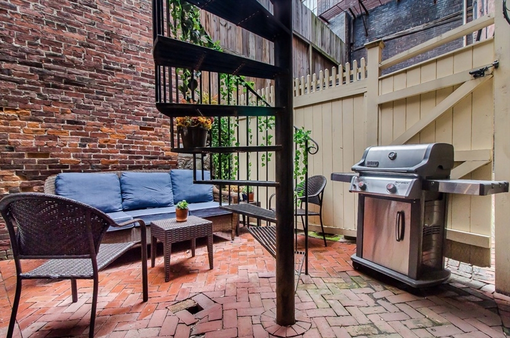 18 Melrose Street, Unit 1 Boston, MA 02116 - Photo 18 of 24 a reading room with furniture and book shelf