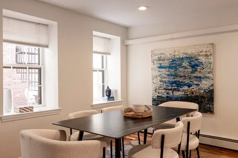 a view of a dining room with furniture and window