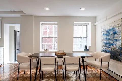 a dining room with furniture and window