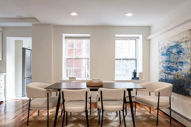 a dining room with furniture and window