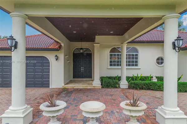 a view of a patio with table and chairs potted plants