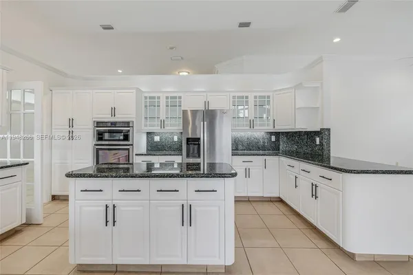 a kitchen with sink cabinets and window