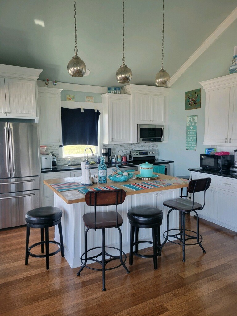 1279 Faggard Road Port Bolivar, TX 77650 - Photo 6 of 14 a outdoor kitchen with a kitchen island furniture and a wooden floor