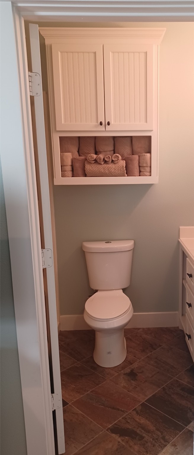 1279 Faggard Road Port Bolivar, TX 77650 - Photo 9 of 14 a bathroom with a toilet a sink and a window