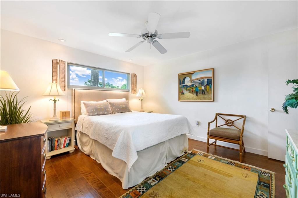 2989 Regatta Road Naples, FL 34103 - Photo 15 of 20 a bedroom with a bed and a chandelier