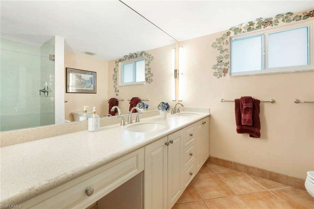 2989 Regatta Road Naples, FL 34103 - Photo 17 of 20 a bathroom with a sink and mirror
