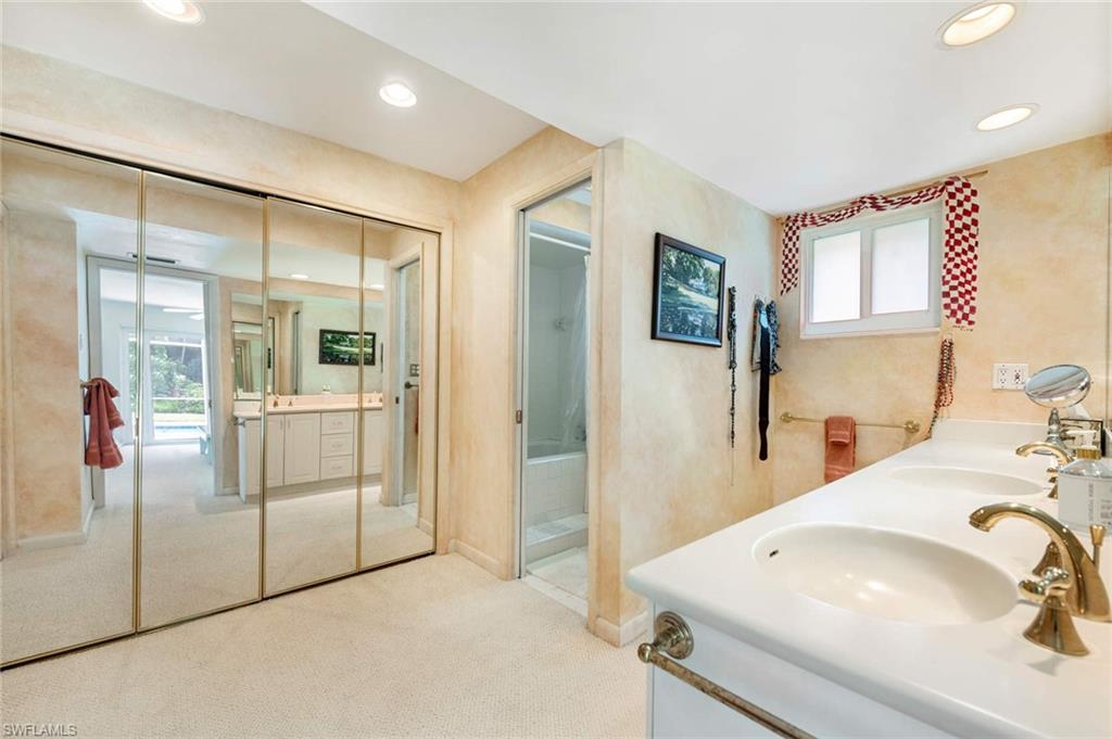 2989 Regatta Road Naples, FL 34103 - Photo 18 of 20 a bathroom with a sink and mirror