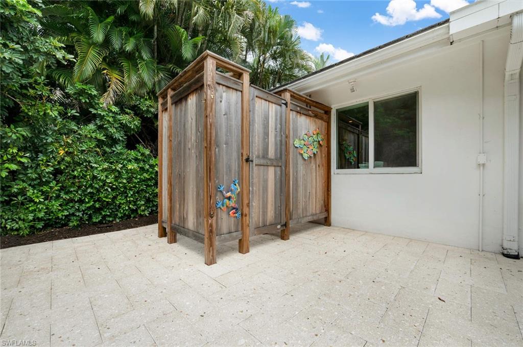 2989 Regatta Road Naples, FL 34103 - Photo 19 of 20 a view of backyard with tub and trees in the background