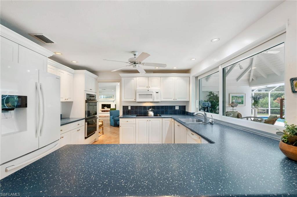 2989 Regatta Road Naples, FL 34103 - Photo 6 of 20 a large kitchen with a large counter top appliances and cabinets