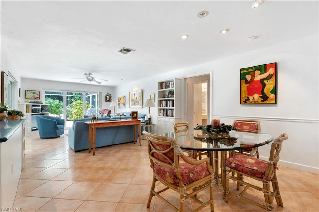 2989 Regatta Road Naples, FL 34103 - Photo 7 of 20 a dining room with furniture and a floor to ceiling window