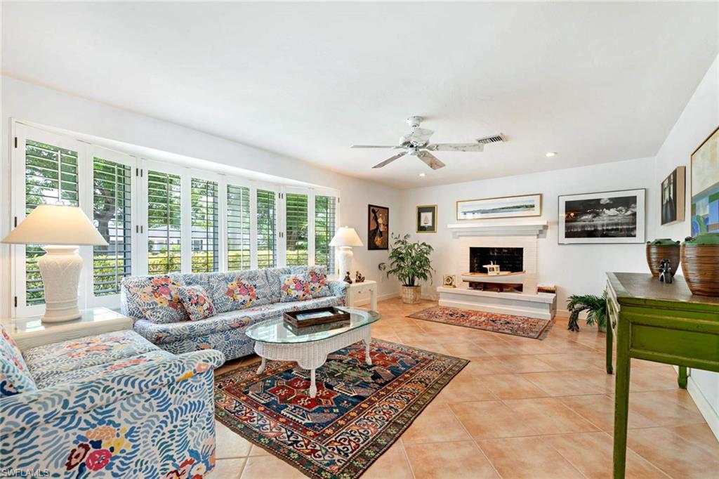 2989 Regatta Road Naples, FL 34103 - Photo 8 of 20 a living room with furniture large window and a table