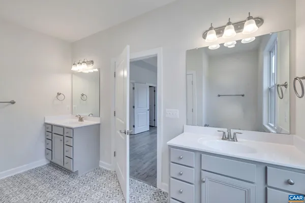 a bathroom with a sink a glass door shower and a mirror