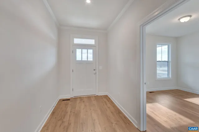 a view of a hallway with wooden floor