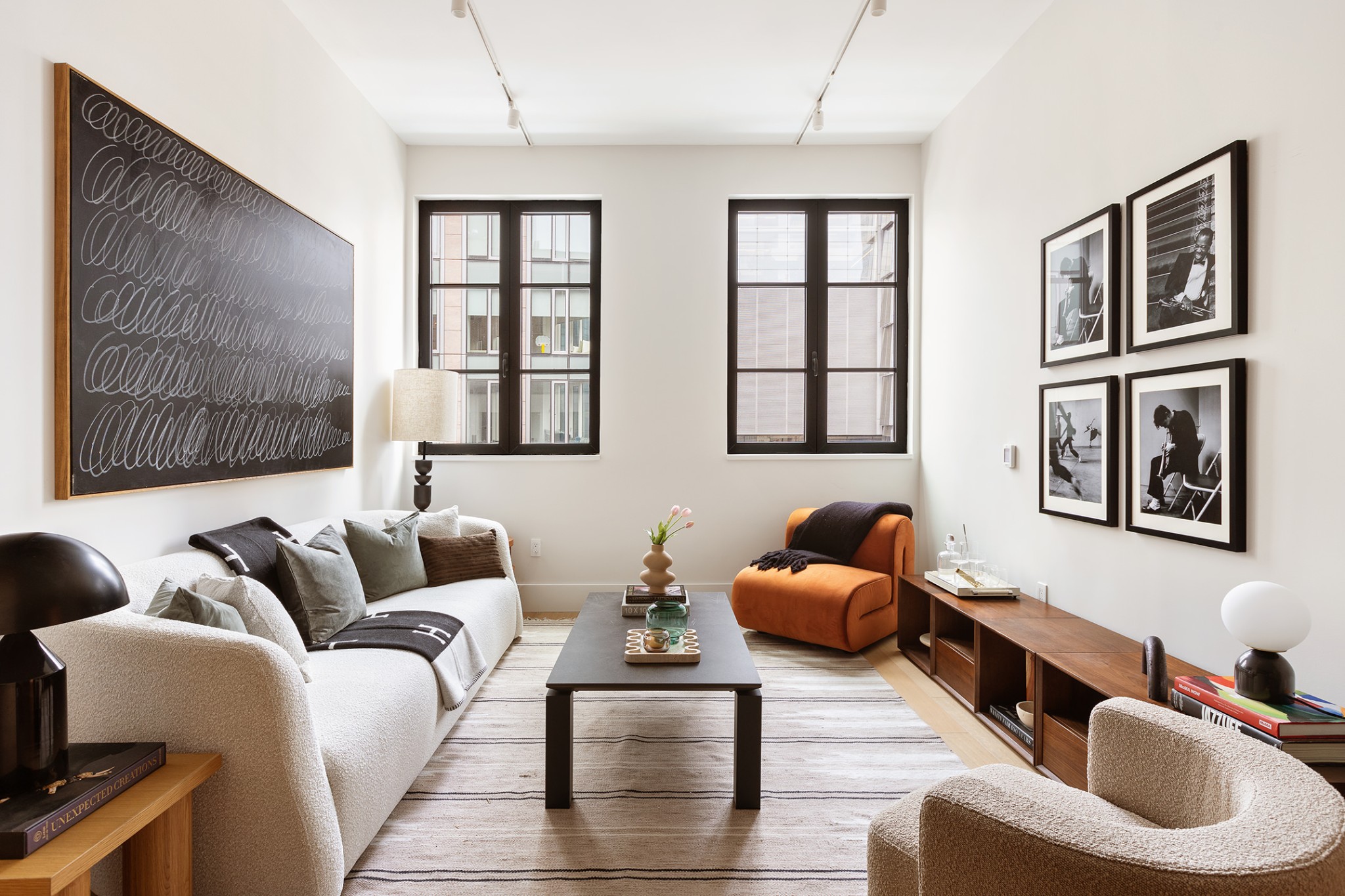 517 West 29th Street, Unit 8H Manhattan, NY 10001 - Photo 2 of 16 a living room with furniture and a large window