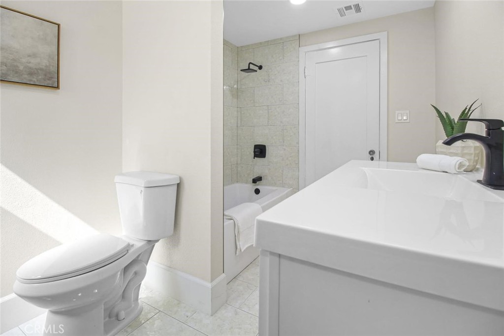 986 West Marshall Boulevard San Bernardino, CA 92405 - Photo 11 of 31 a bathroom with a sink a toilet and shower