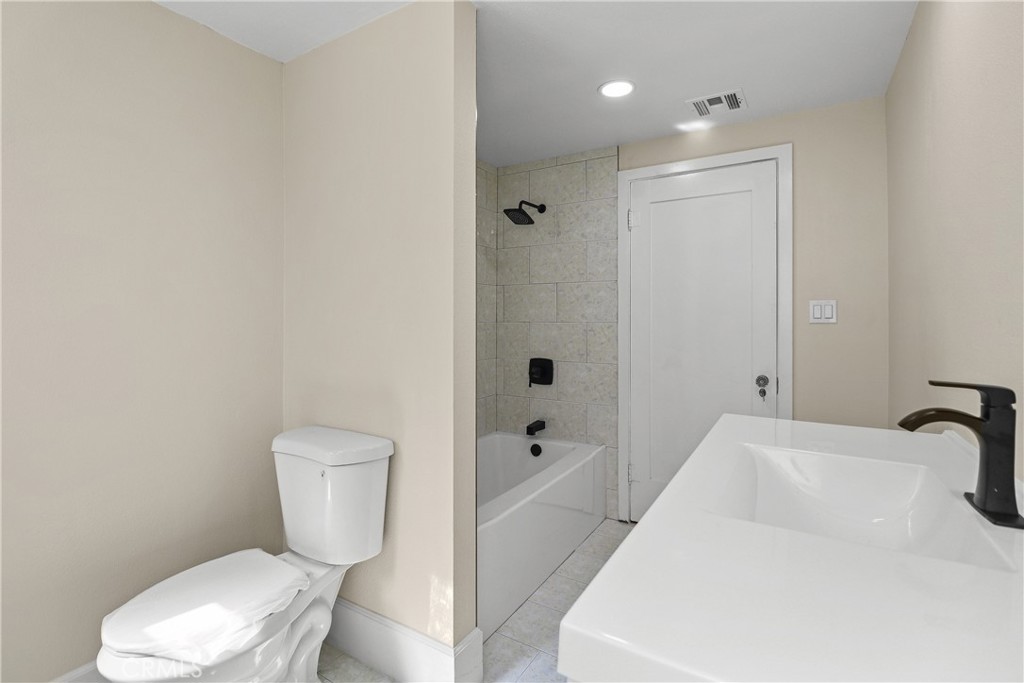 986 West Marshall Boulevard San Bernardino, CA 92405 - Photo 12 of 31 a white toilet sitting next to a bathroom sink