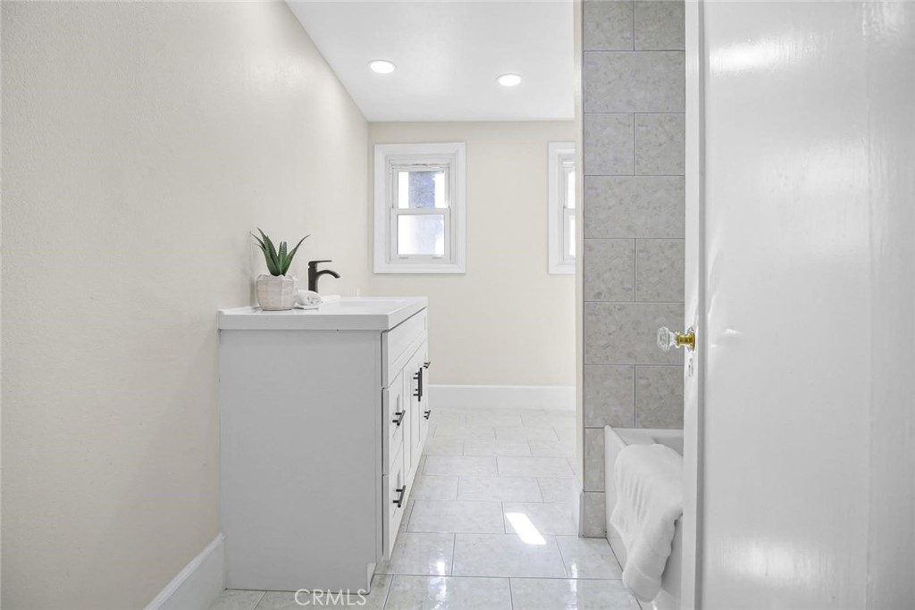986 West Marshall Boulevard San Bernardino, CA 92405 - Photo 14 of 31 a bathroom with a sink mirror and toilet