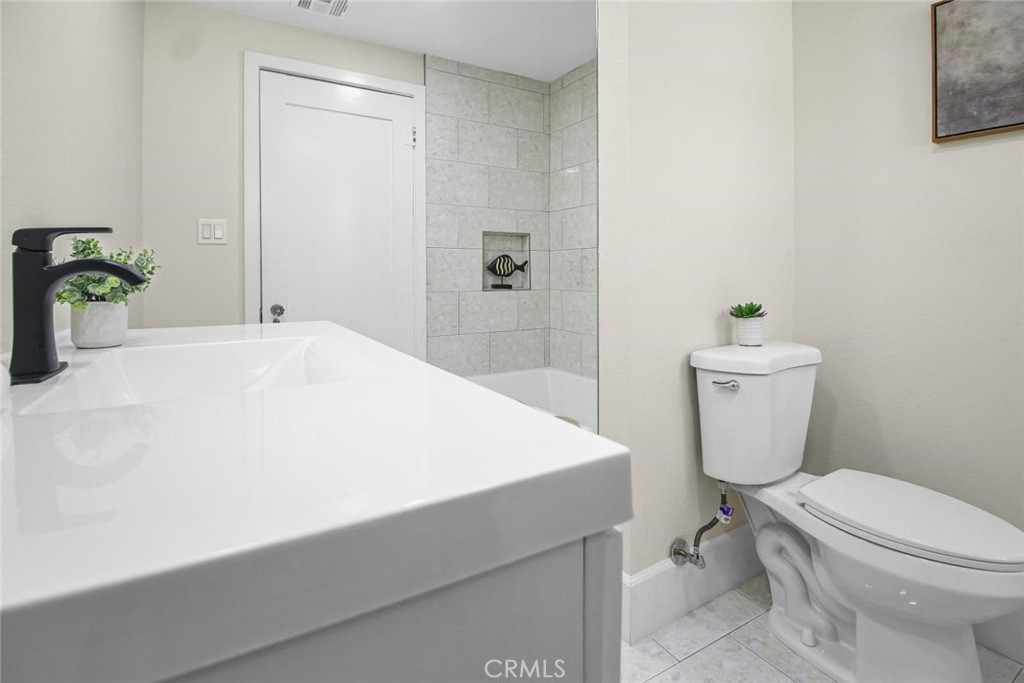 986 West Marshall Boulevard San Bernardino, CA 92405 - Photo 15 of 31 a white toilet sitting next to a bathroom sink