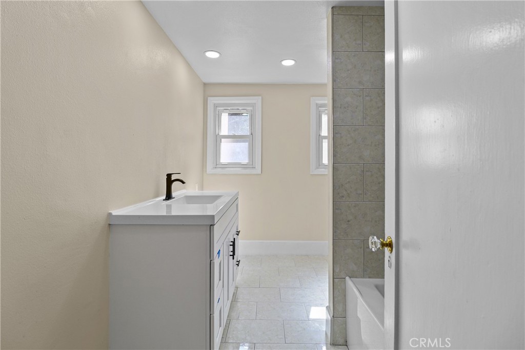 986 West Marshall Boulevard San Bernardino, CA 92405 - Photo 16 of 31 a view of a bathroom with a sink and mirror