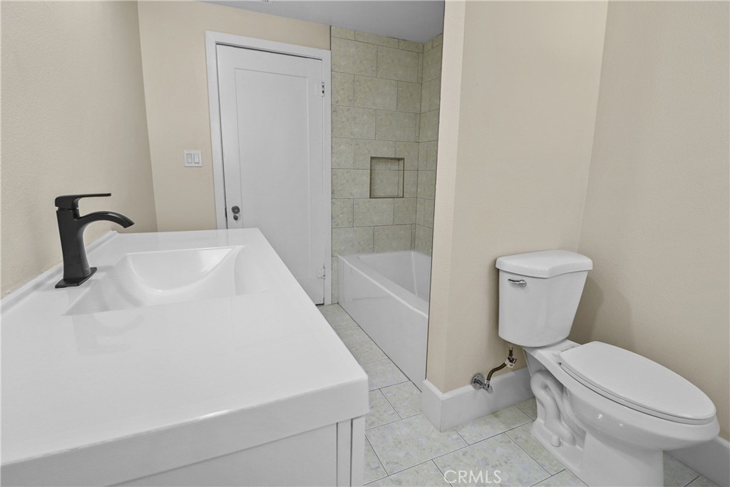 986 West Marshall Boulevard San Bernardino, CA 92405 - Photo 18 of 31 a bathroom with a sink toilet and shower