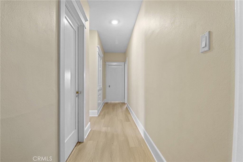 986 West Marshall Boulevard San Bernardino, CA 92405 - Photo 19 of 31 a view of a hallway with wooden floor