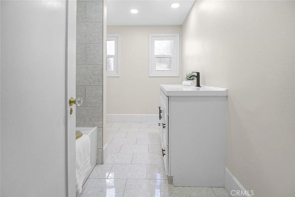 986 West Marshall Boulevard San Bernardino, CA 92405 - Photo 26 of 31 a bathroom with a sink a toilet and shower