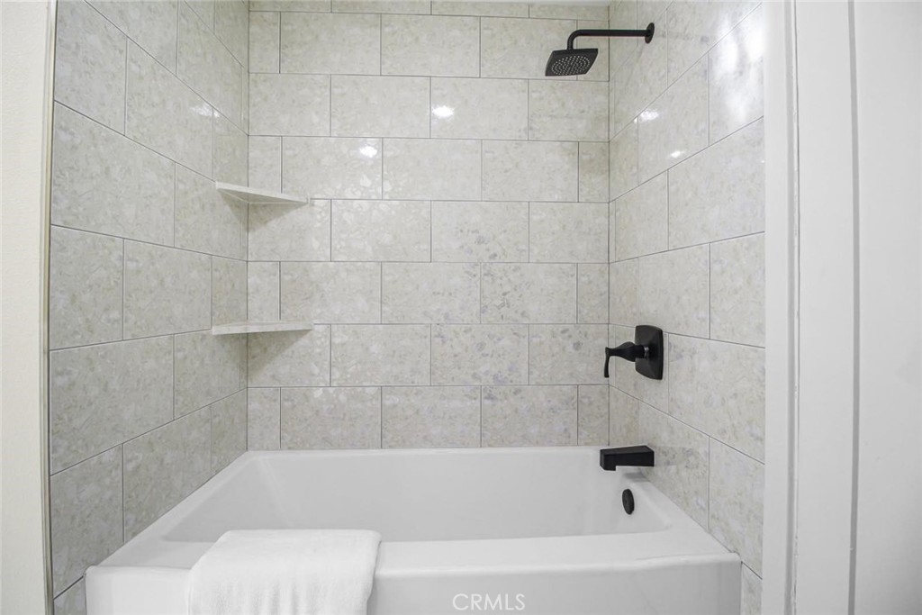 986 West Marshall Boulevard San Bernardino, CA 92405 - Photo 27 of 31 a bathroom with a bathtub and a shower