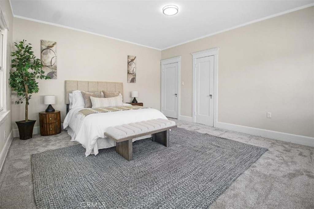 986 West Marshall Boulevard San Bernardino, CA 92405 - Photo 29 of 31 a bed sitting in a spacious bedroom next to a window and a potted plant