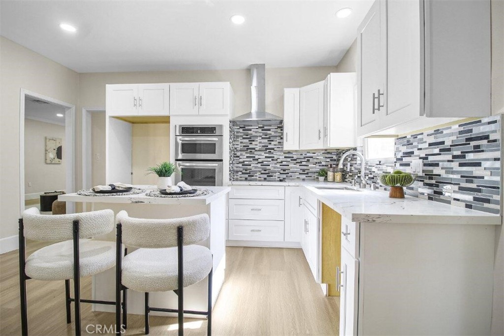 986 West Marshall Boulevard San Bernardino, CA 92405 - Photo 6 of 31 a kitchen with white cabinets and stainless steel appliances