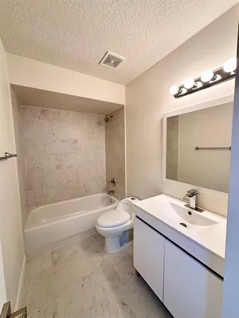 a bathroom with a double vanity sink toilet mirror and bathtub