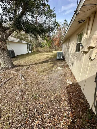 a view of a yard with wooden fence