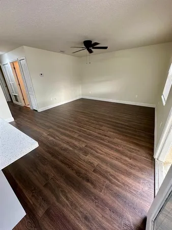 a view of a room with wooden floor