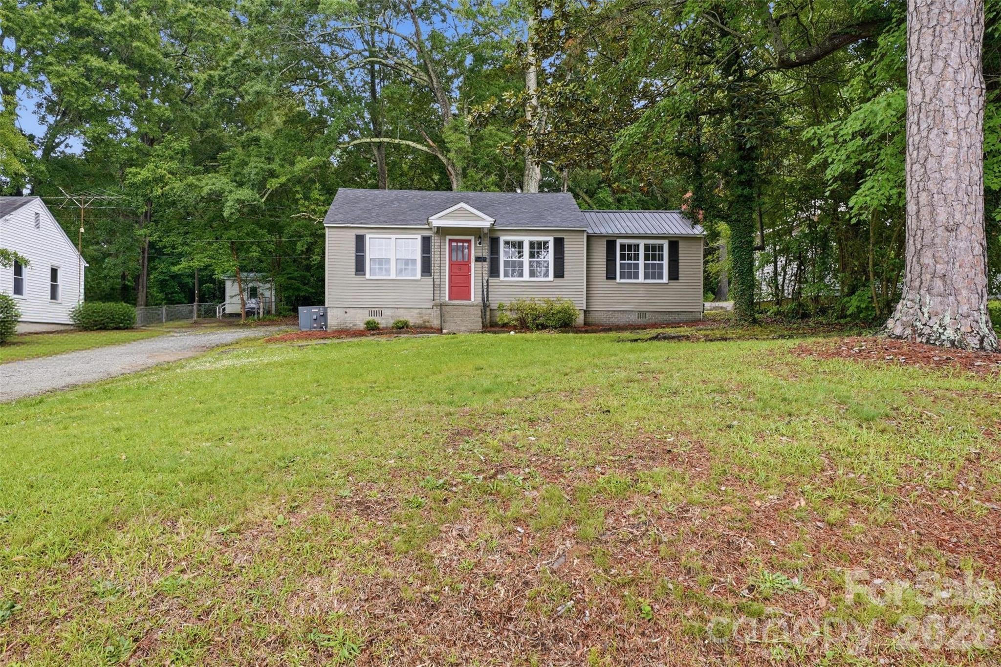 128 Ella Street Chester, SC 29706 - Photo 1 of 18 a view of a yard in front of a house with large trees