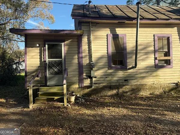 a view of a chairs and table in the patio