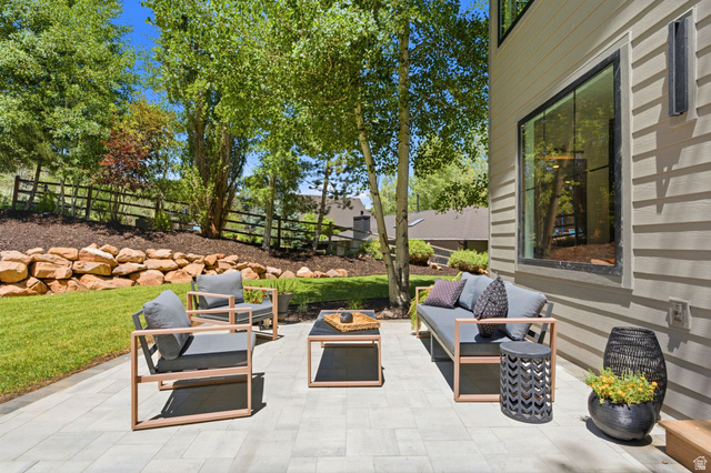 3027 Homestead Road Park City, UT 84098 - Photo 56 of 62 Expansive paved patio with a horizontal siding exterior, large black-trimmed windows, and exterior sconce lighting