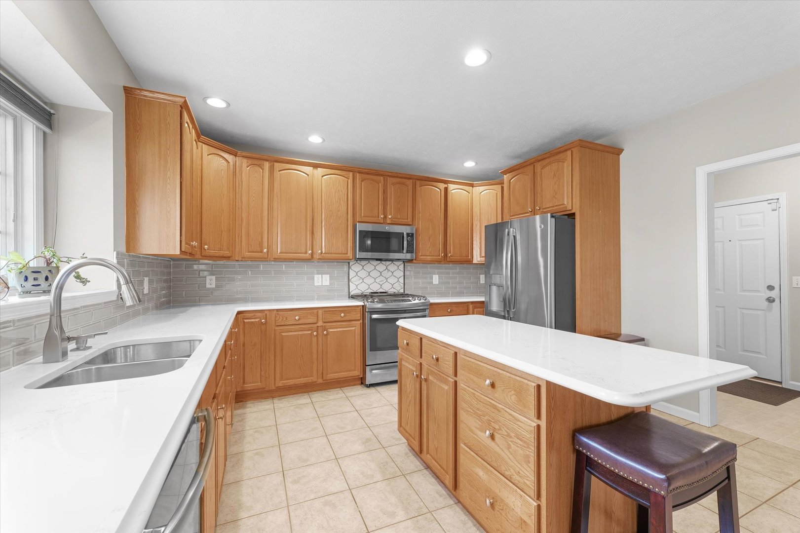3908 Turnberry Drive Champaign, IL 61822 - Photo 11 of 49 a kitchen with stainless steel appliances granite countertop a sink refrigerator and cabinets