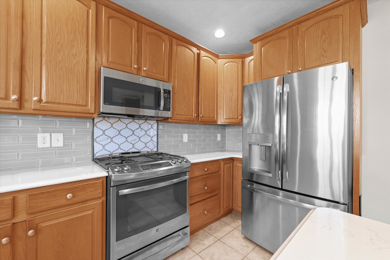 3908 Turnberry Drive Champaign, IL 61822 - Photo 13 of 49 a kitchen with granite countertop a refrigerator stove and microwave