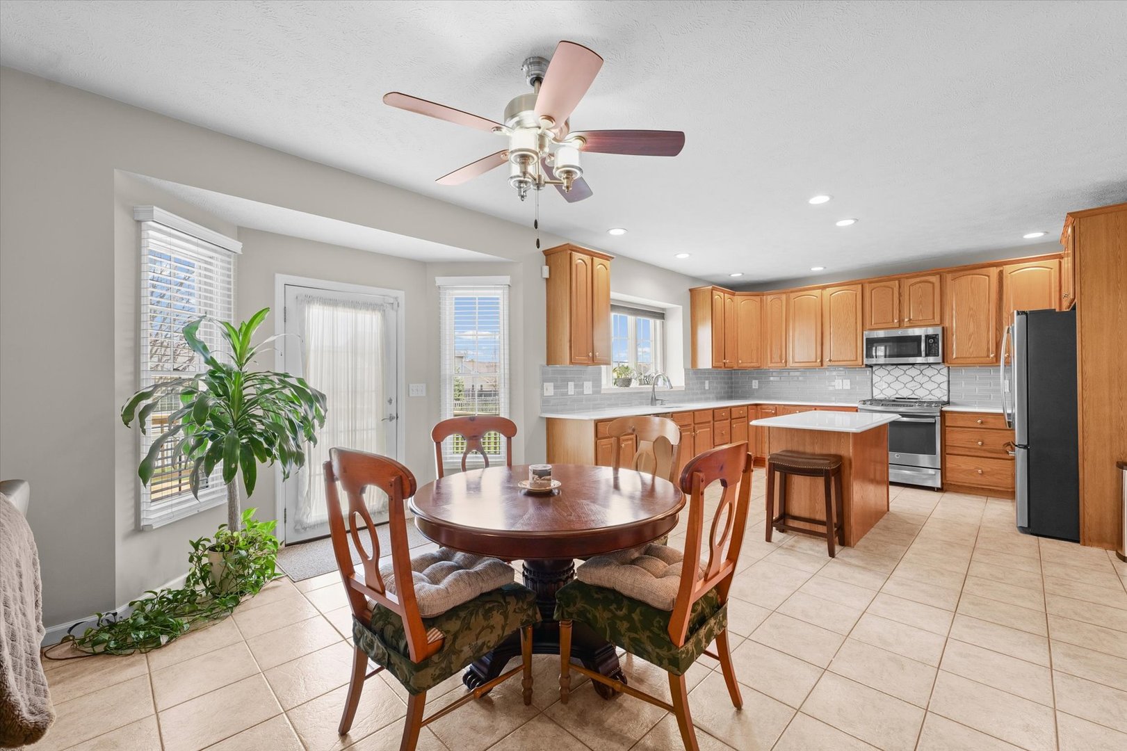 3908 Turnberry Drive Champaign, IL 61822 - Photo 15 of 49 a dining room with a large window table and chairs