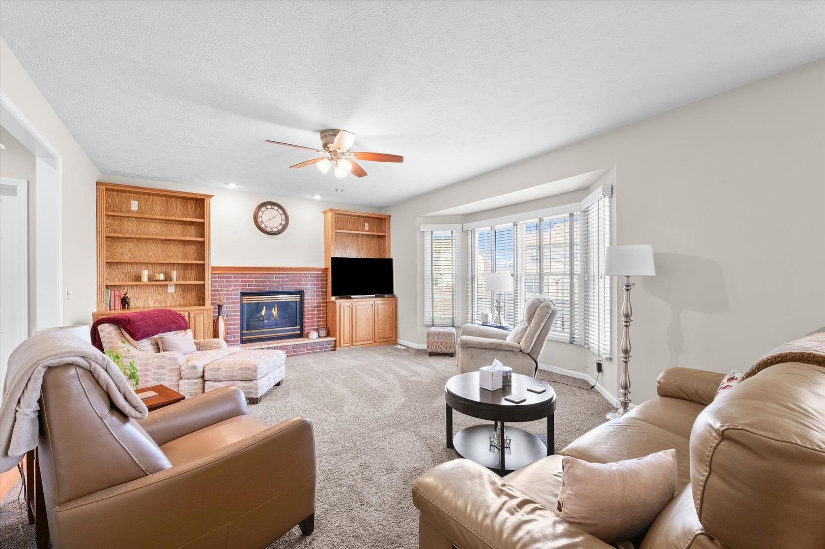 3908 Turnberry Drive Champaign, IL 61822 - Photo 17 of 49 a living room with furniture fireplace and a large window