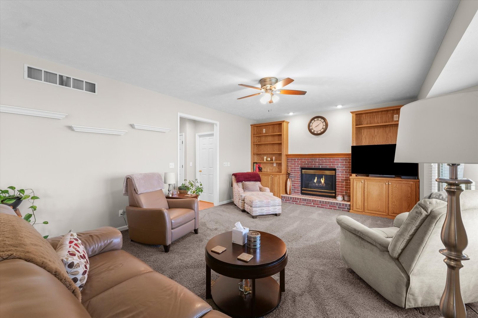 3908 Turnberry Drive Champaign, IL 61822 - Photo 18 of 49 a living room with furniture a fireplace and a window