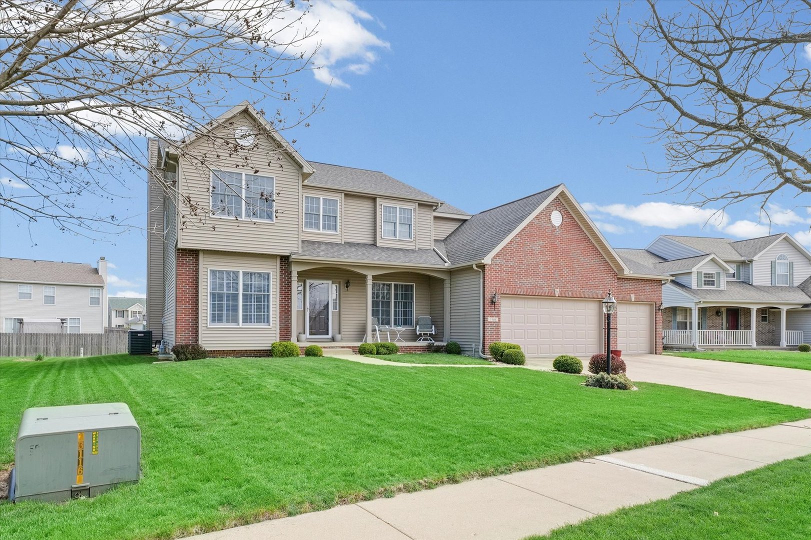 3908 Turnberry Drive Champaign, IL 61822 - Photo 2 of 49 a front view of a house with a yard and trees