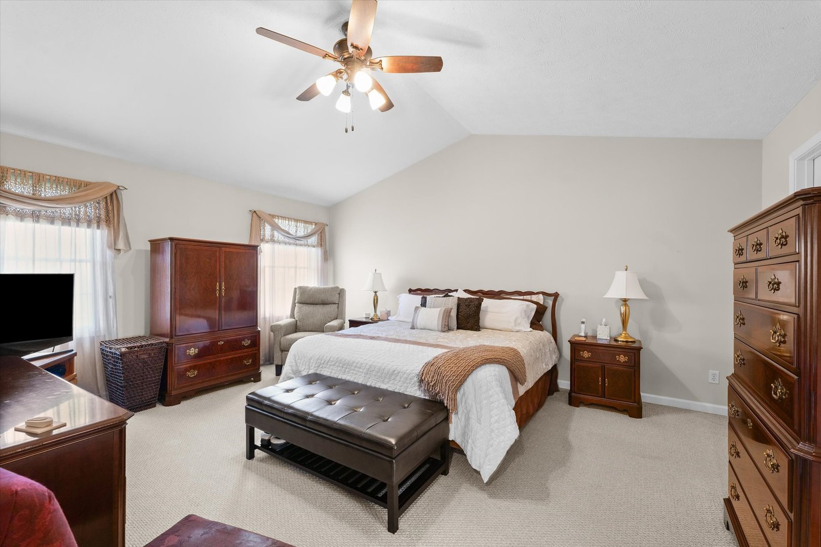 3908 Turnberry Drive Champaign, IL 61822 - Photo 25 of 49 a spacious bedroom with a bed a couch and a flat tv screen on a dresser