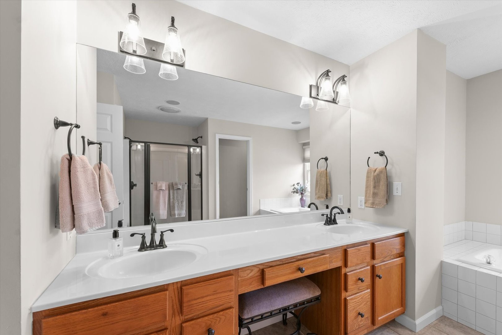 3908 Turnberry Drive Champaign, IL 61822 - Photo 28 of 49 a bathroom with a double vanity sink a mirror and a shower