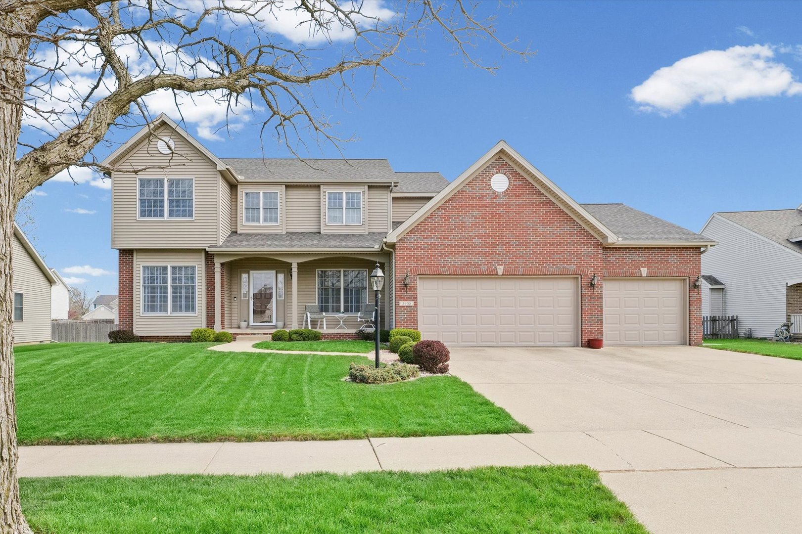 3908 Turnberry Drive Champaign, IL 61822 - Photo 3 of 49 a front view of a house with a yard and garage