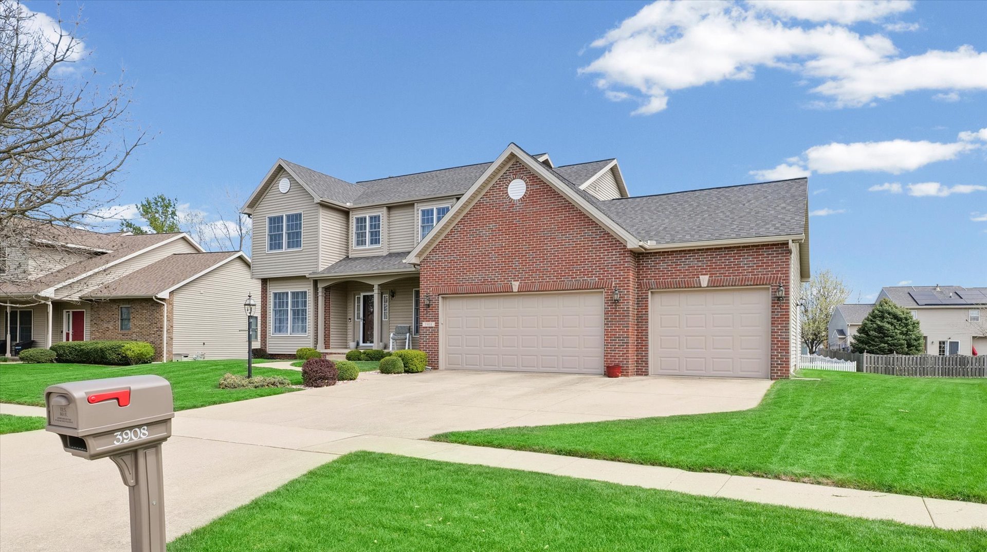 3908 Turnberry Drive Champaign, IL 61822 - Photo 4 of 49 a front view of a house with a yard and garage
