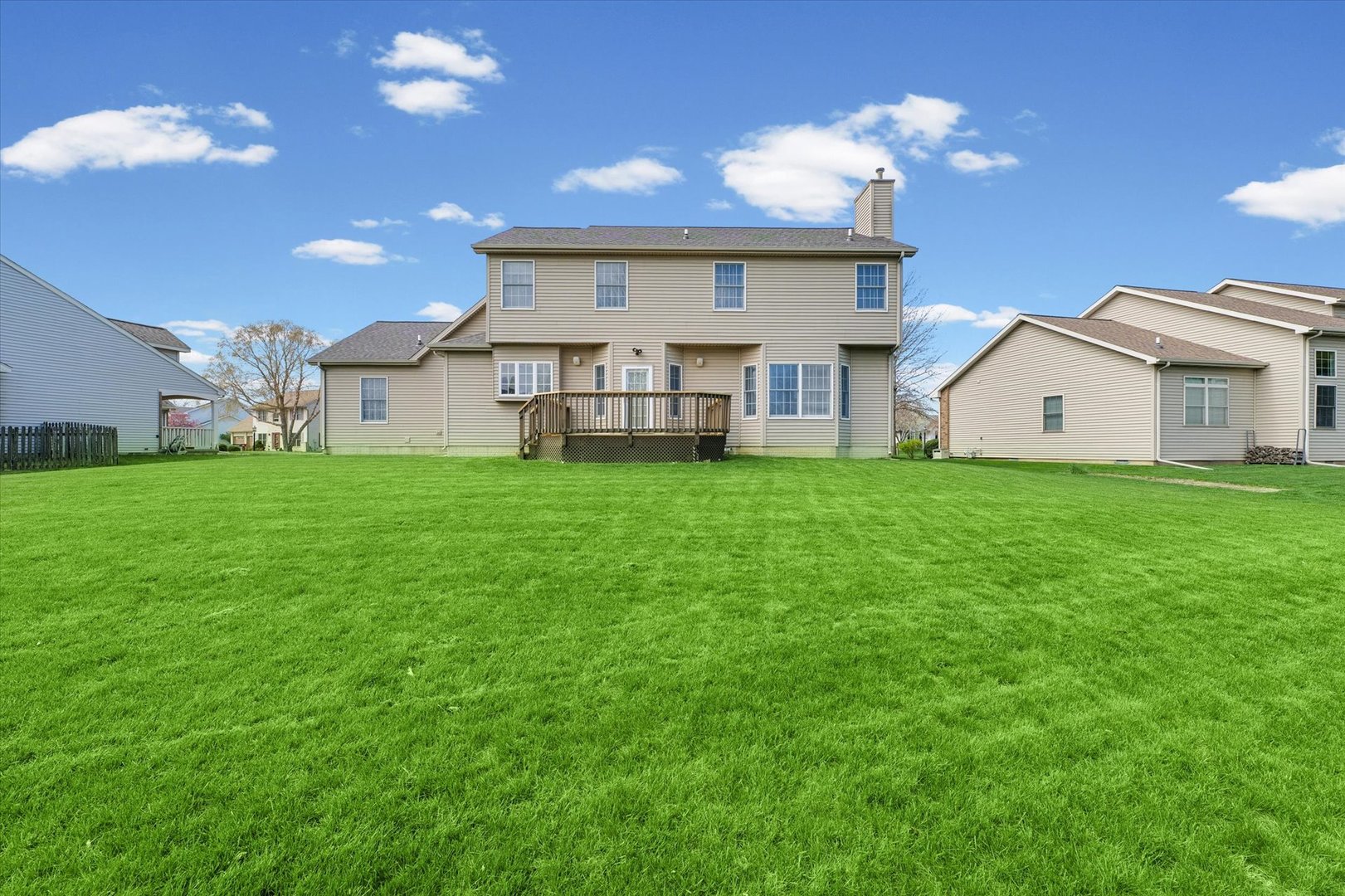 3908 Turnberry Drive Champaign, IL 61822 - Photo 45 of 49 a view of a house with a big yard and large windows