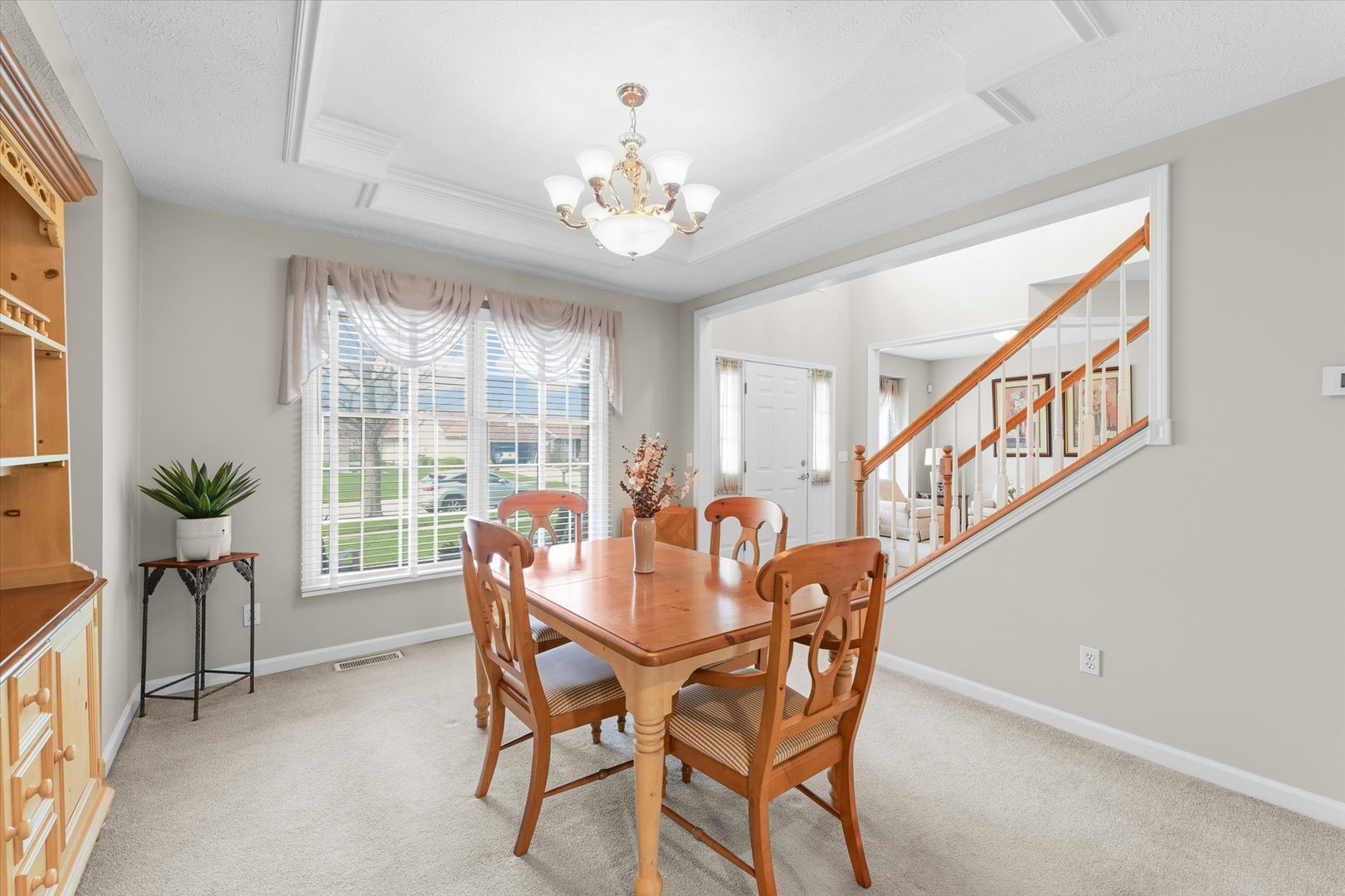 3908 Turnberry Drive Champaign, IL 61822 - Photo 9 of 49 a dining room with furniture potted plants and a chandelier