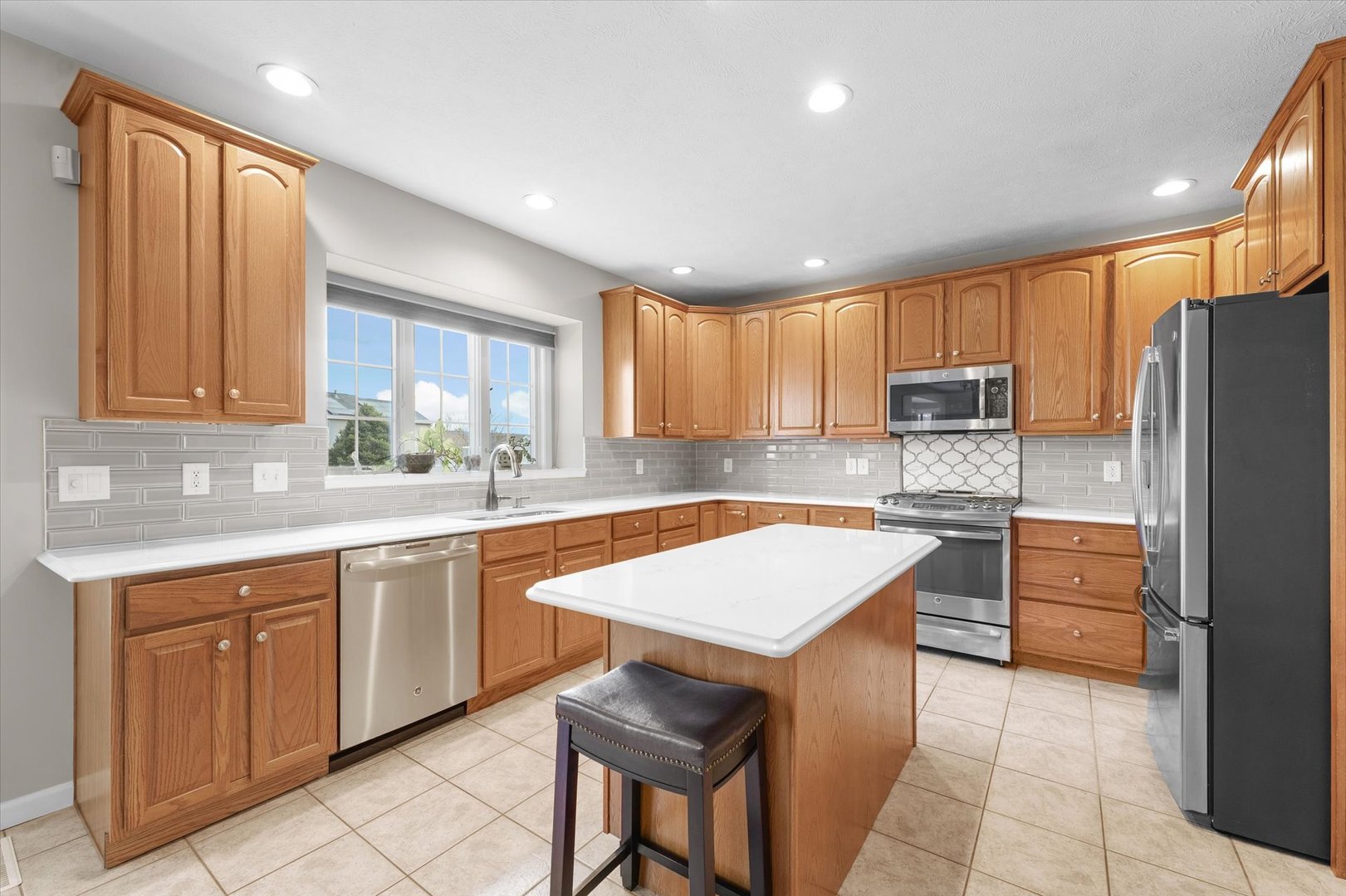 3908 Turnberry Drive Champaign, IL 61822 - Photo 10 of 49 a kitchen with stainless steel appliances granite countertop a refrigerator sink and cabinets