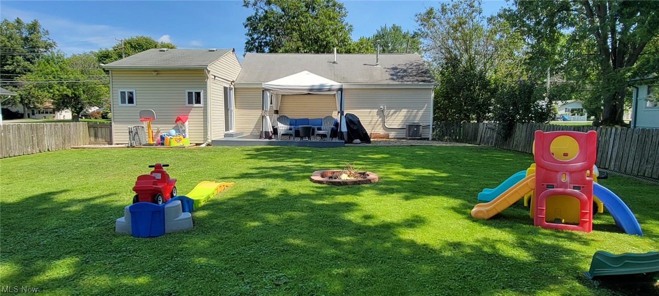 5770 Jaycox Road North Ridgeville, OH 44039 - Photo 23 of 31 Back of house featuring a yard, a firepit, and a playground