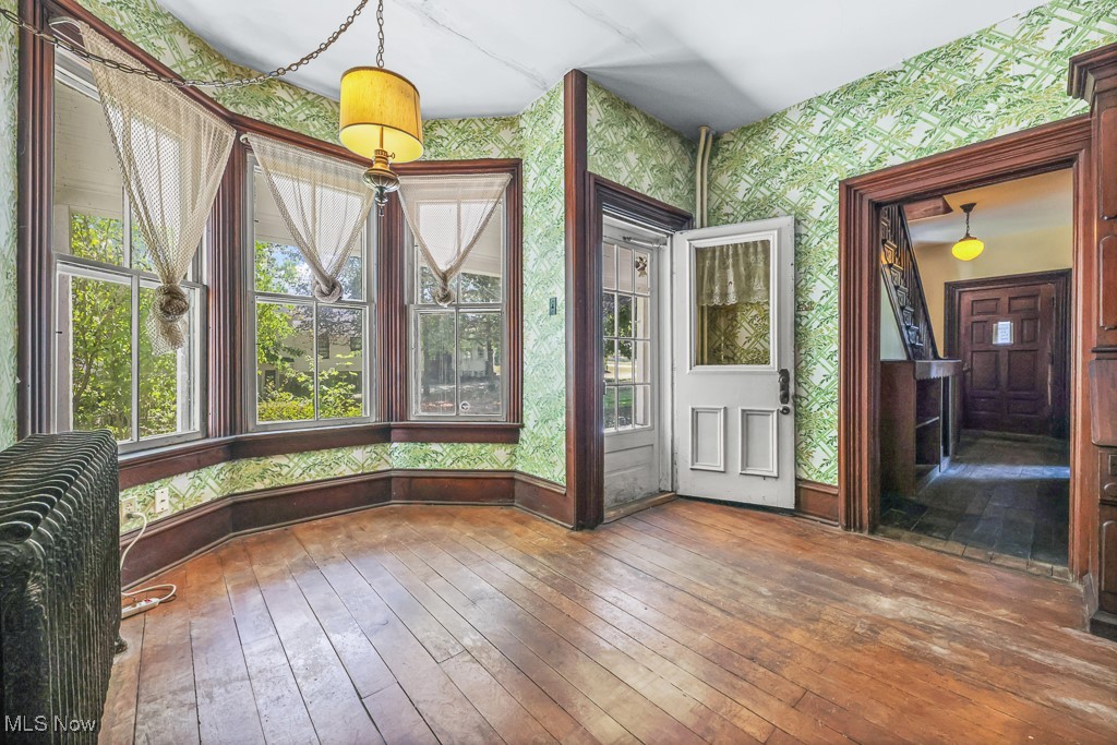 6727 Waterloo Road Atwater, OH 44201 - Photo 11 of 48 Unfurnished sunroom with wallpapered walls and hardwood / wood-style floors